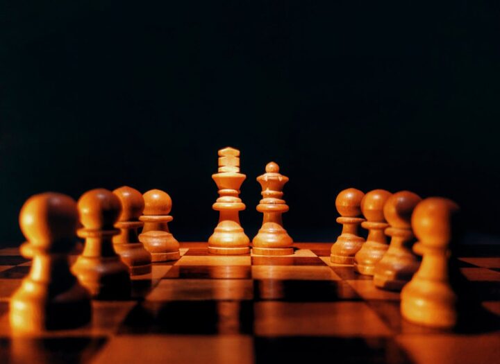 brown chess pieces on brown wooden chess board